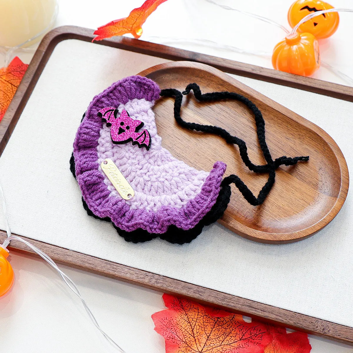 Halloween themed gold-label yarn bib with bat design, festive pet accessory.