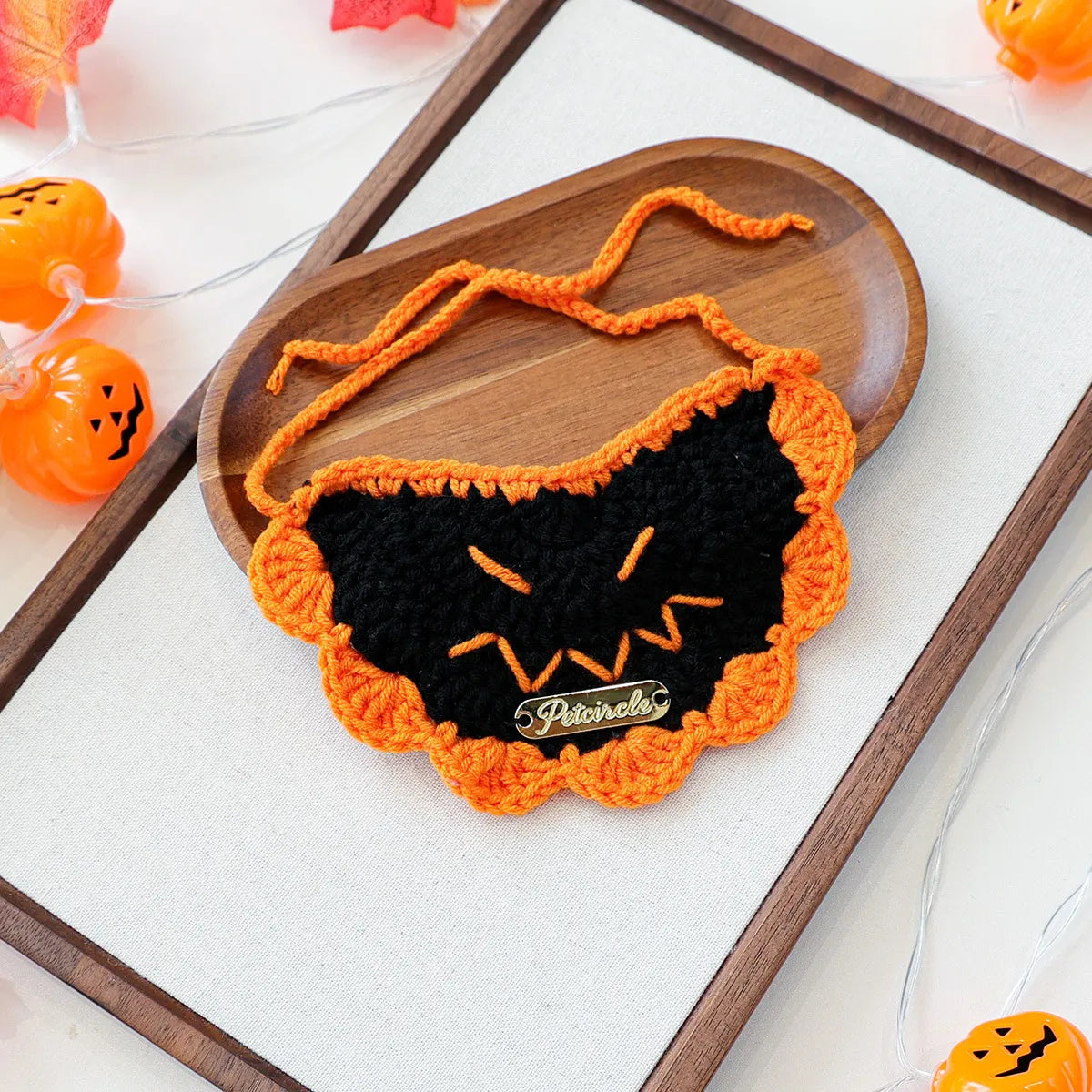 Festive Halloween bib with black pumpkin embroidery, pet fashion accessory.