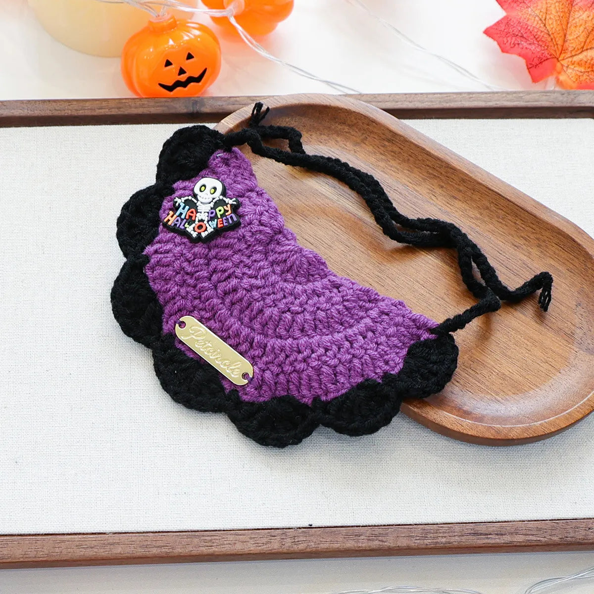 Orange pumpkin design yarn bib with witch hat detail, Halloween pet wear.