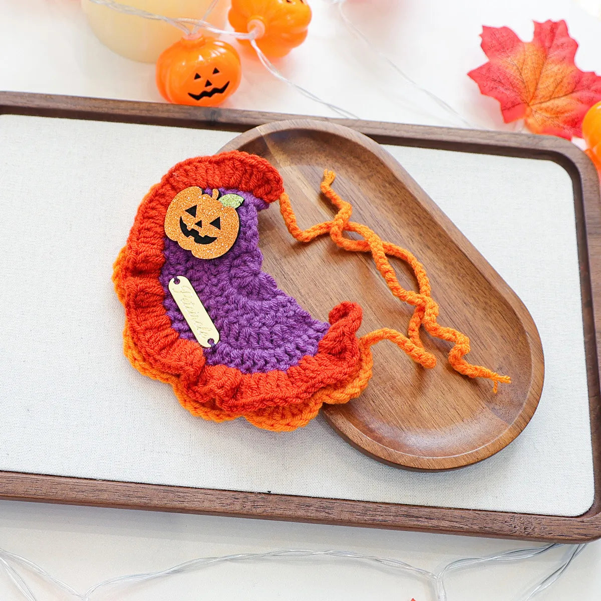 Classic orange pumpkin themed gold-label yarn bib, festive Halloween style.