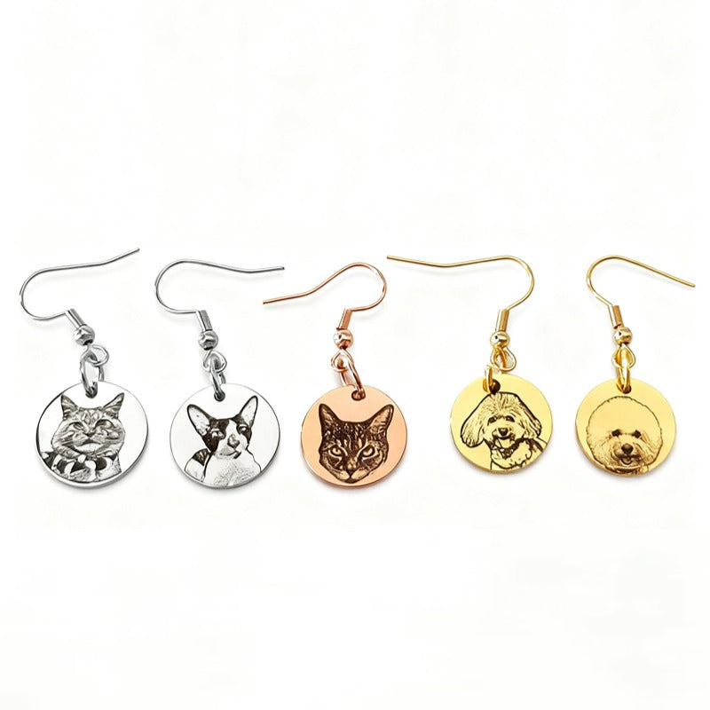 Flat lay of custom pet face earrings in gold and silver styles
