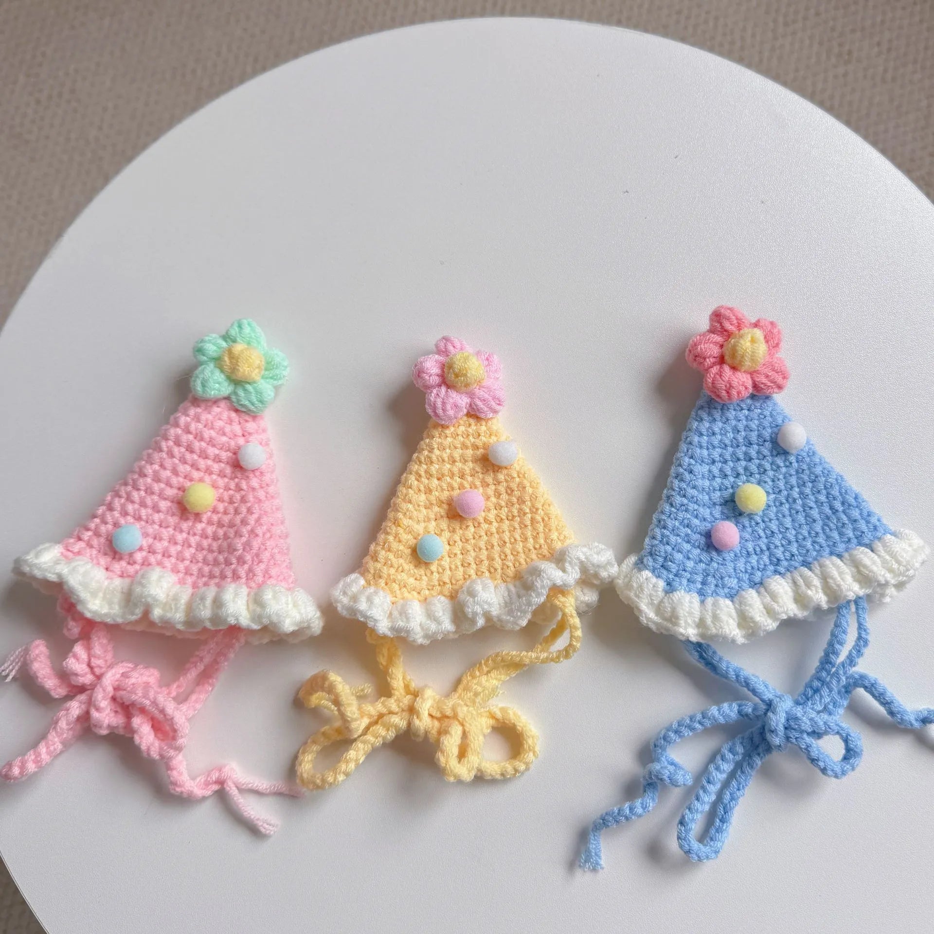 Pastel-colored knitted birthday hats for pets