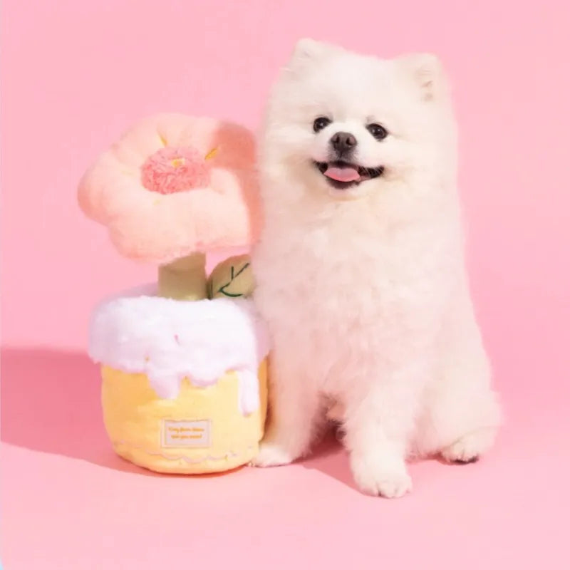 Dog with pink plush flower bouquet toy