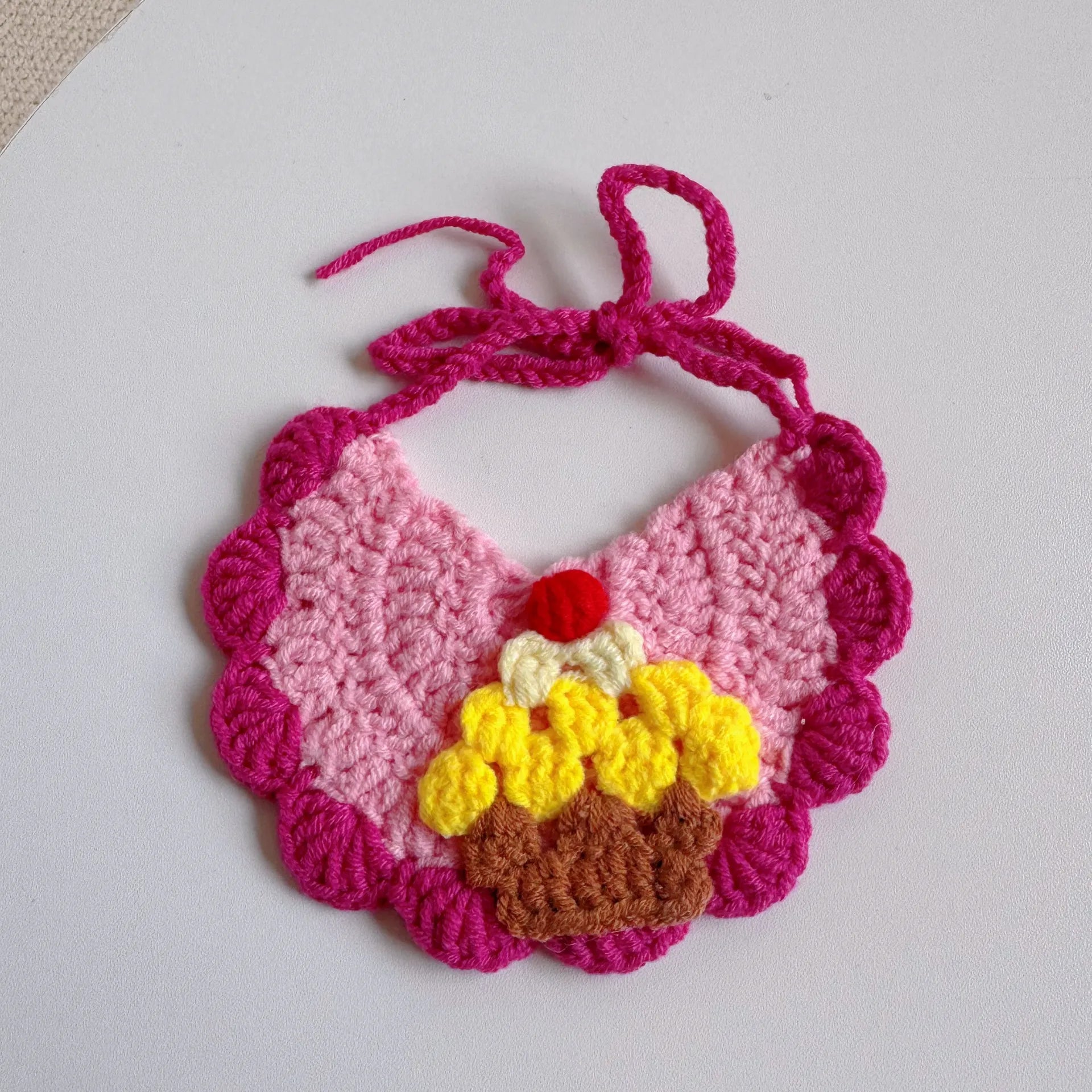 Rose red pet bib with knitted birthday cake design