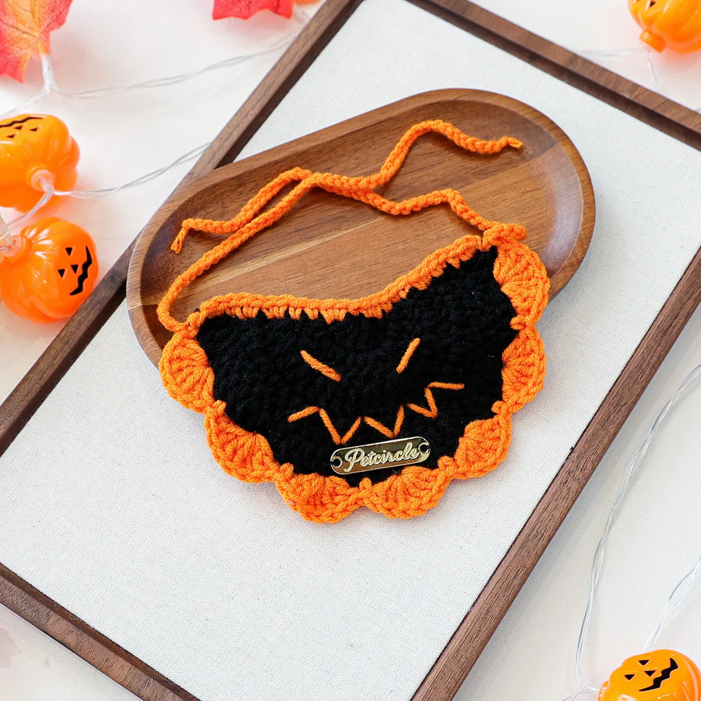 Festive Halloween bib with black pumpkin embroidery, pet fashion accessory.
