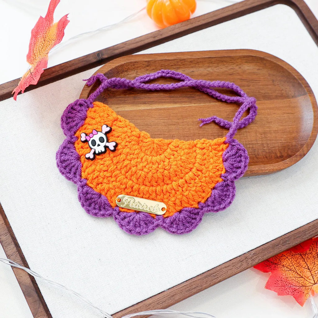 Halloween themed gold-label yarn bib with skull and lettering design.

