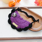 Orange pumpkin design yarn bib with witch hat detail, Halloween pet wear.
