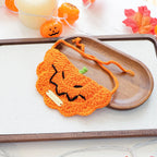 Halloween bib featuring a skull design with gold-label yarn, spooky pet accessory.
