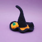Close-up of navy blue Halloween pet witch hat with festive design
