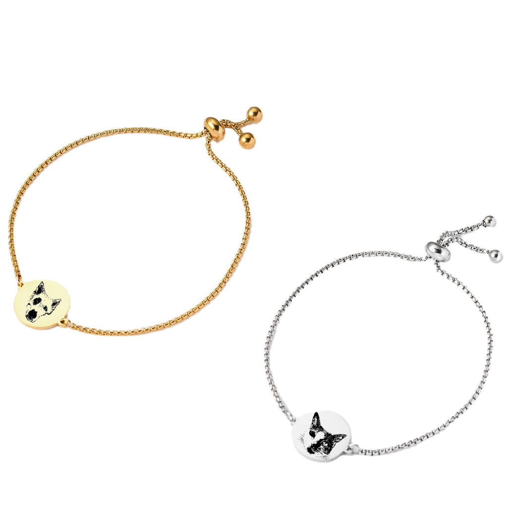 Flat lay of personalized pet face bracelets with round pendants in gold and silver.

