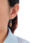 Woman wearing custom pet face earrings for fashion display
