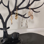 Jewelry tree display showing multiple custom pet face earring styles
