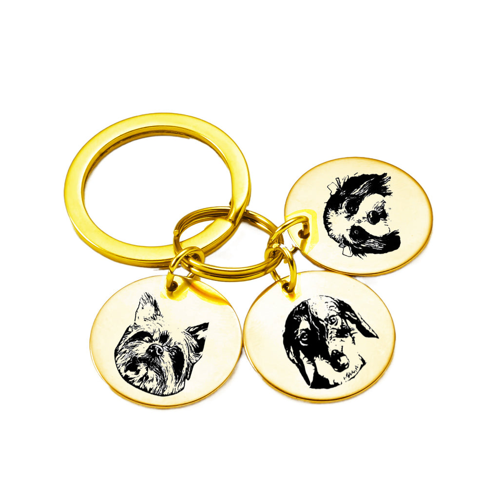 Gold custom pet face keychain with three engraved pendants for multiple pets.
