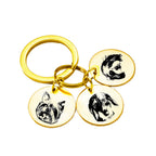 Gold custom pet face keychain with three engraved pendants for multiple pets.
