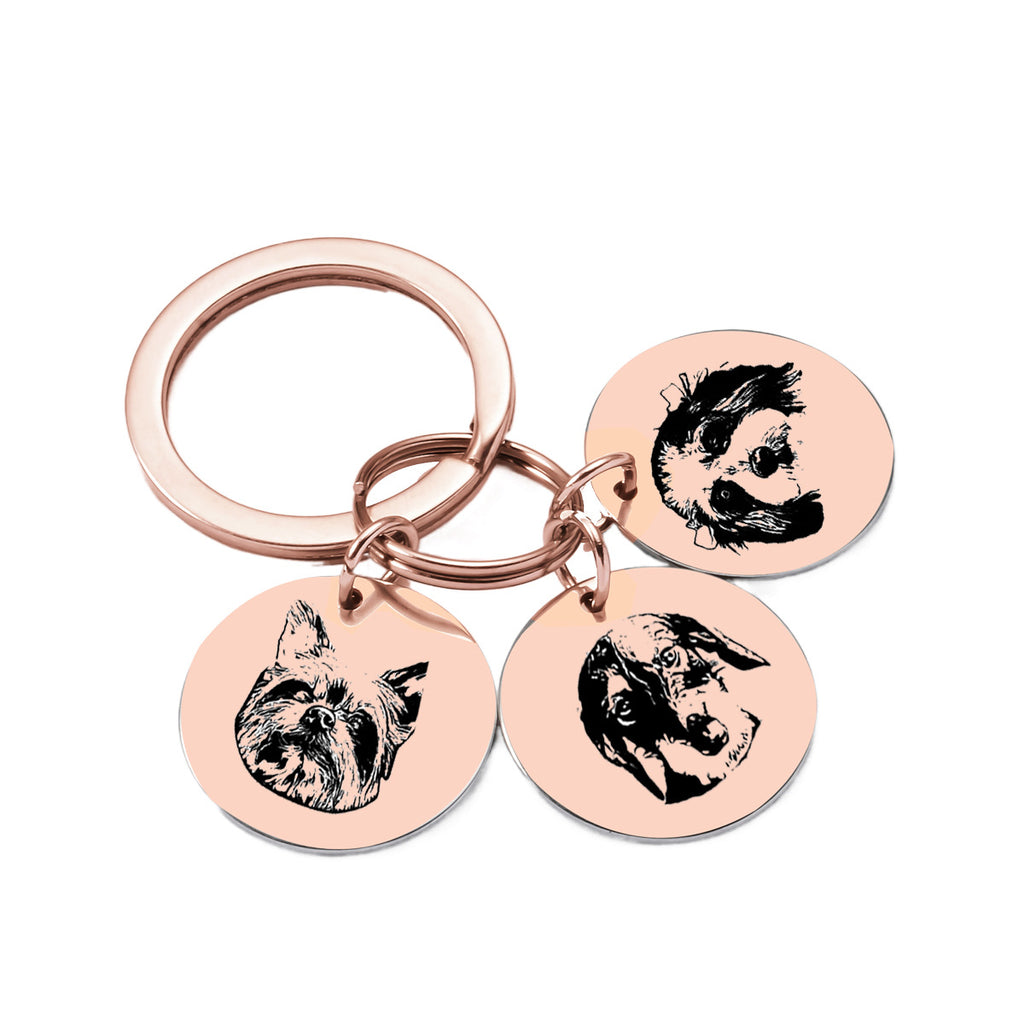 Rose gold keychain with three custom engraved pet photo pendants.
