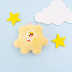 Yellow plush one-eyed pet toy with cheerful design
