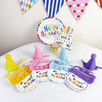 Multicolor birthday bib and hat sets flat lay