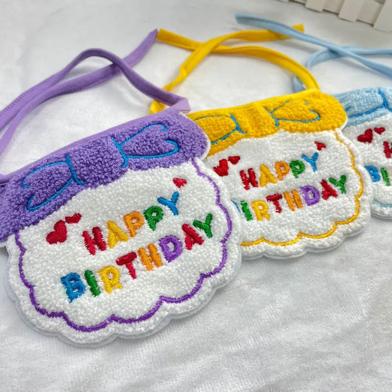 Close-up of purple and yellow birthday bibs