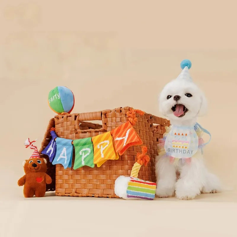 Dogs playing with birthday party toy set on floor