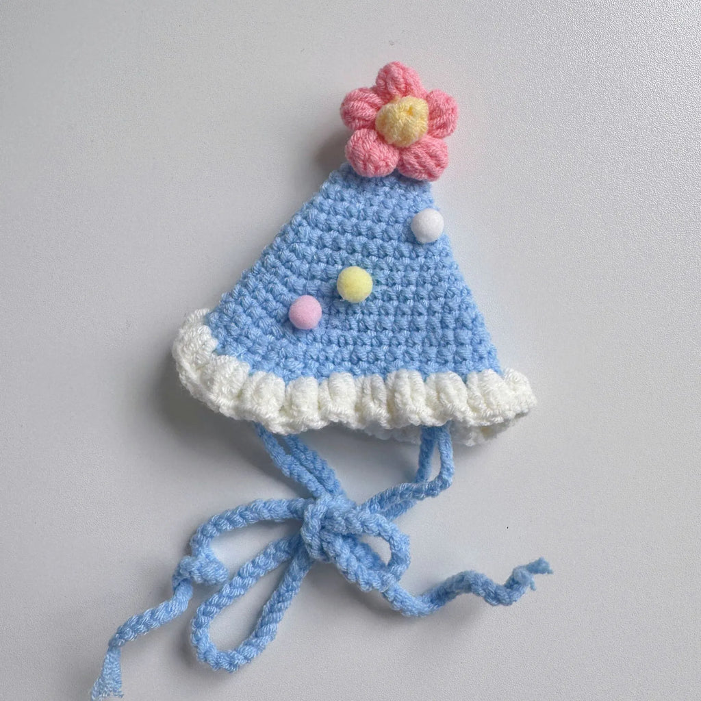 Blue knitted pet bib with smiley face design