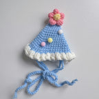 Blue knitted pet bib with smiley face design