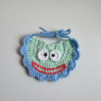 Blue knitted pet bib with teddy bear patch