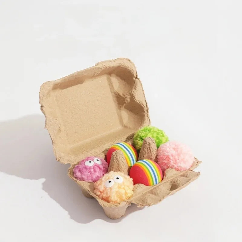 Cat surrounded by colorful egg-shaped yarn balls