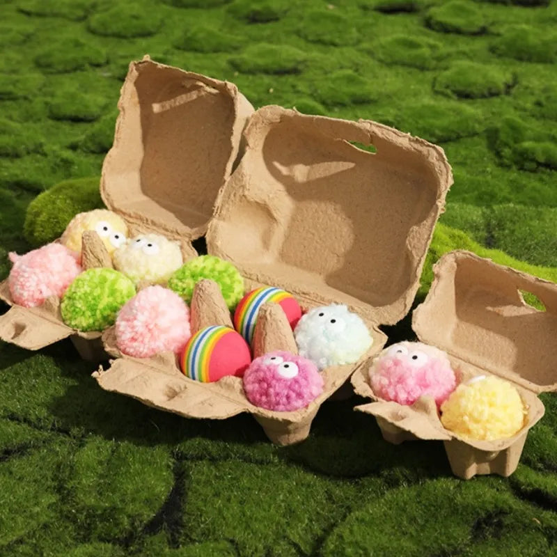 Pastel egg-shaped yarn balls in a kraft egg box