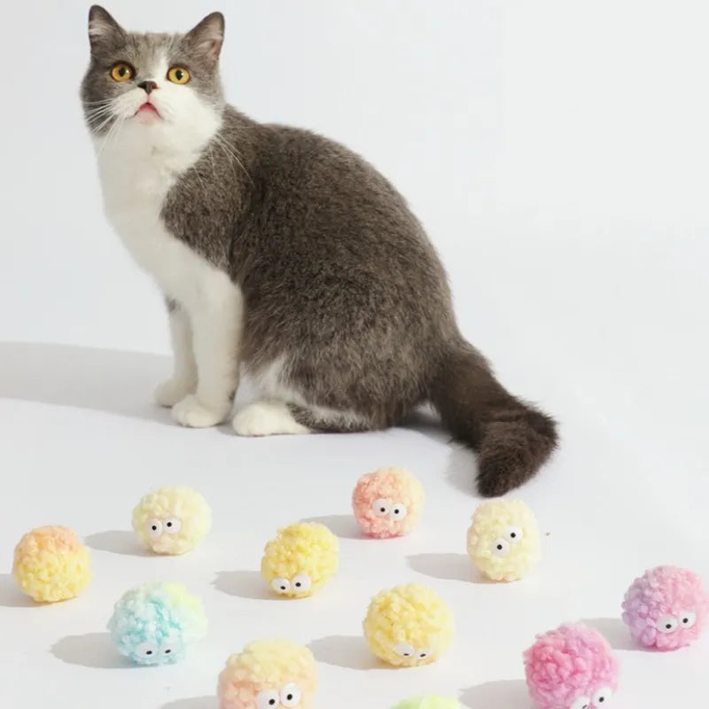 Cat surrounded by colorful egg-shaped yarn balls
