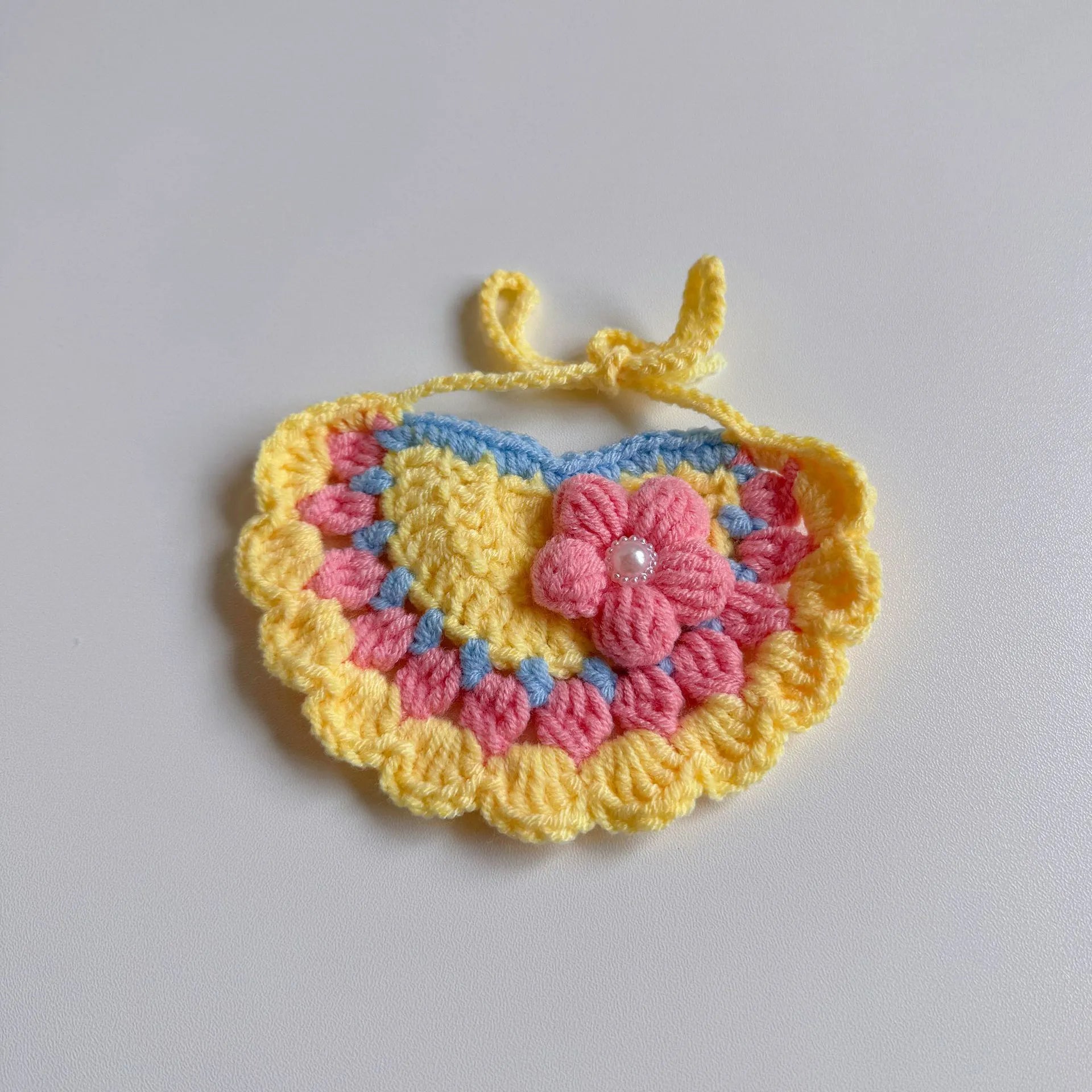 Pink knitted pet birthday hat with pom-pom