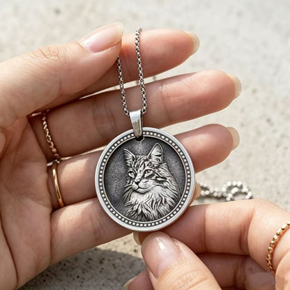 Hand holding custom silver pet pendant showing actual size