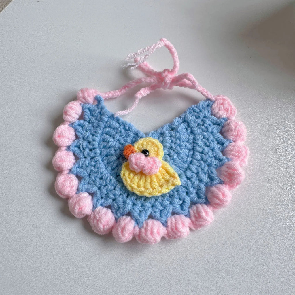 Yellow pet bib with duckling design and pink pom-poms